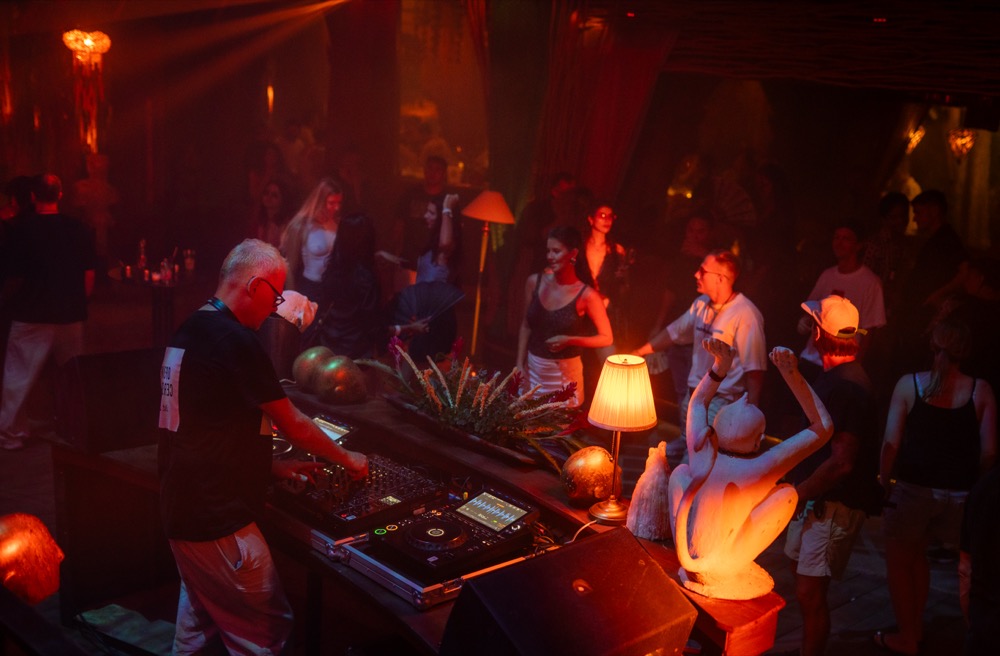 DJ set with dancers on stage at BABOU
