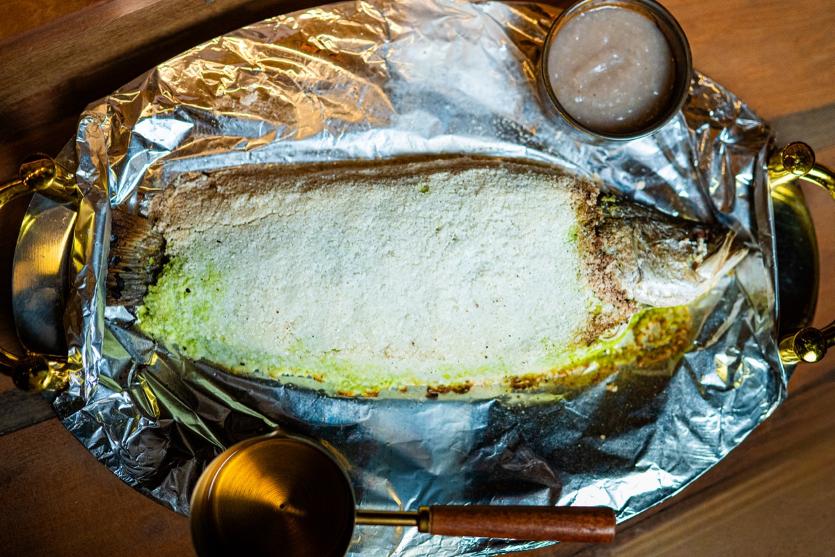 A whole fish baked in a salt crust at BABOU