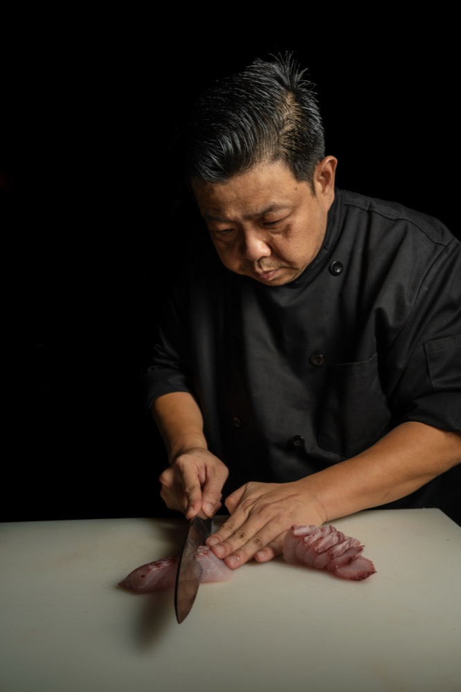 BABOU's chef slicing fresh sashimi