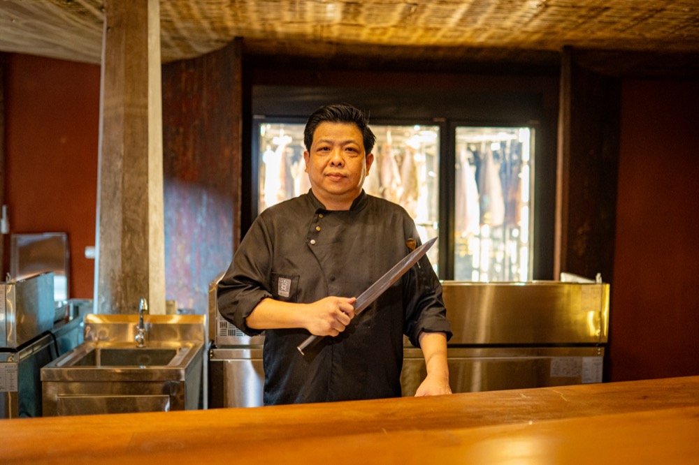 BABOU's chef in the kitchen holding a knife