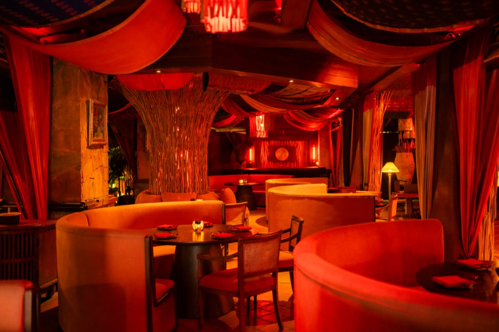 BABOU's Lounge, circular red booths under draped canopy lighting